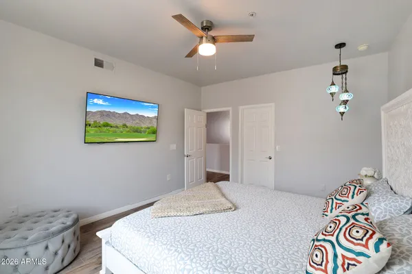 a bedroom with a bed and a chandelier