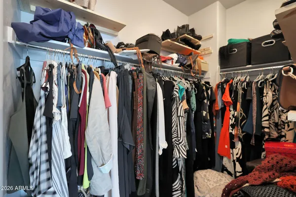 a view of walk in closet with clothes