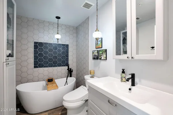 a bathroom with a toilet a sink and bathtub