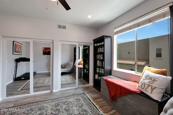 a bedroom with furniture and a rug