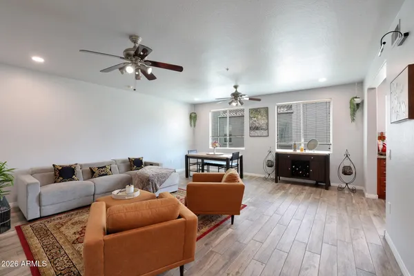 a living room with furniture and a wooden floor