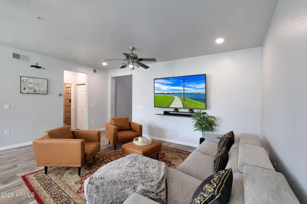 a living room with furniture ceiling fan and a rug