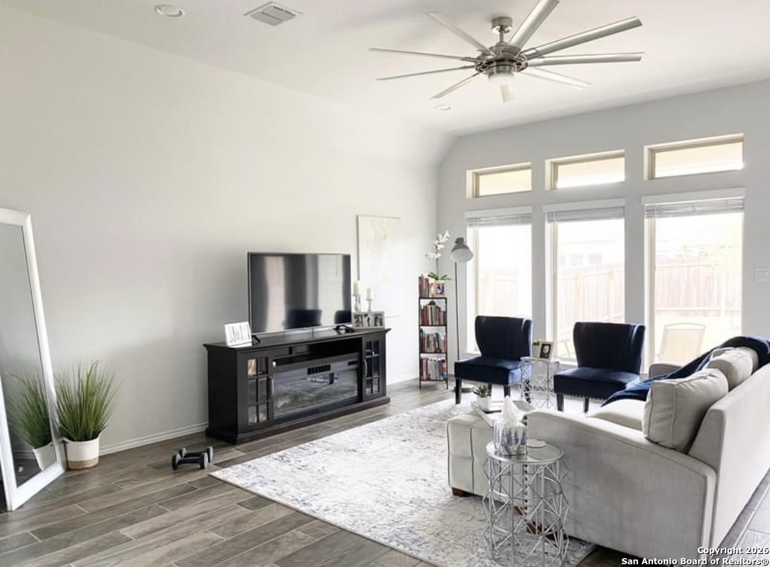 a living room with furniture a large window with wooden floor