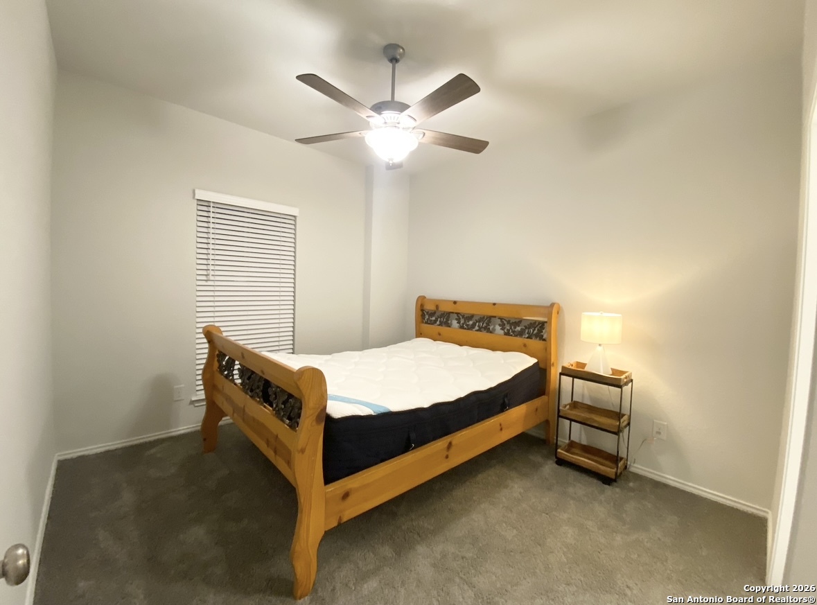 9358 Boiling Rapid San Antonio, TX 78254 - Photo 12 of 22 a bed sitting in a bedroom next to a window