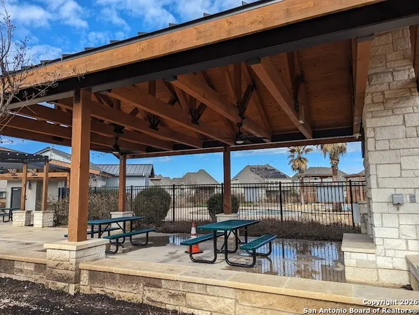 a view of a chairs and table in patio