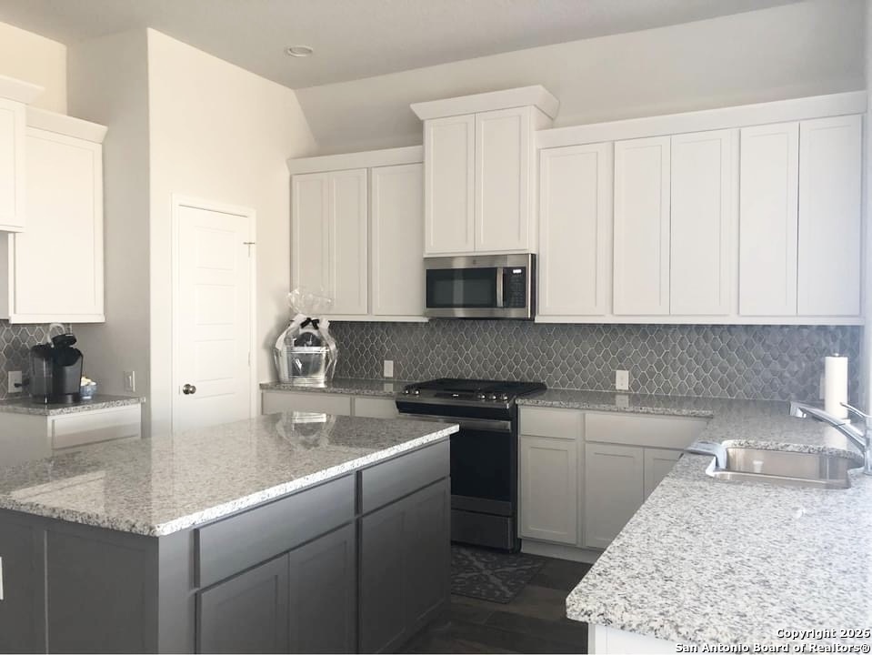 9358 Boiling Rapid San Antonio, TX 78254 - Photo 3 of 22 a kitchen with stainless steel appliances granite countertop a sink stove and cabinets