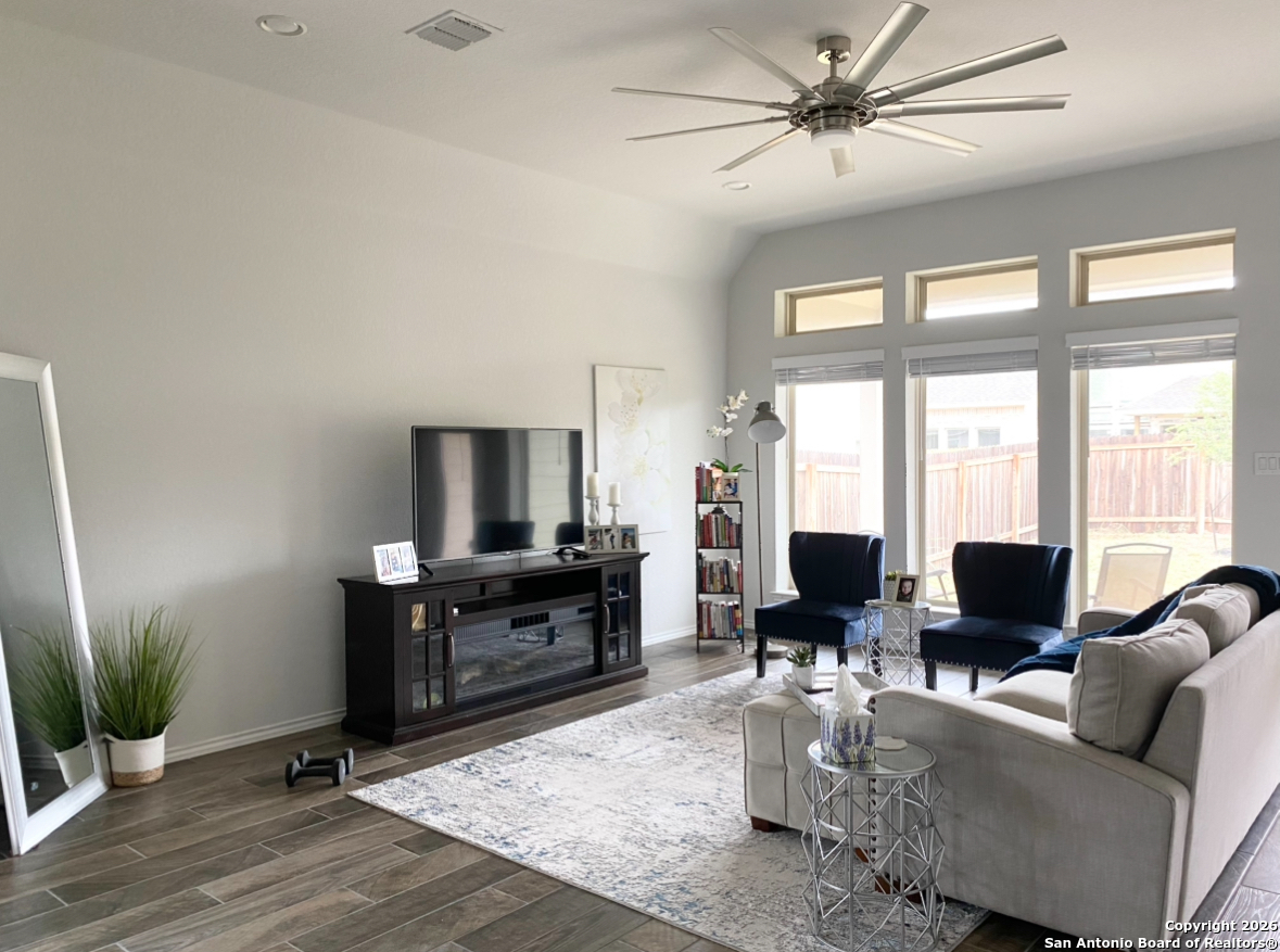 9358 Boiling Rapid San Antonio, TX 78254 - Photo 4 of 22 a living room with furniture a large window with wooden floor