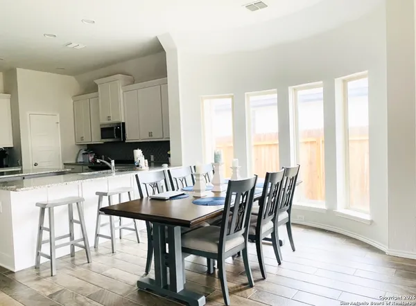 a view of a dining room with furniture and wooden floor