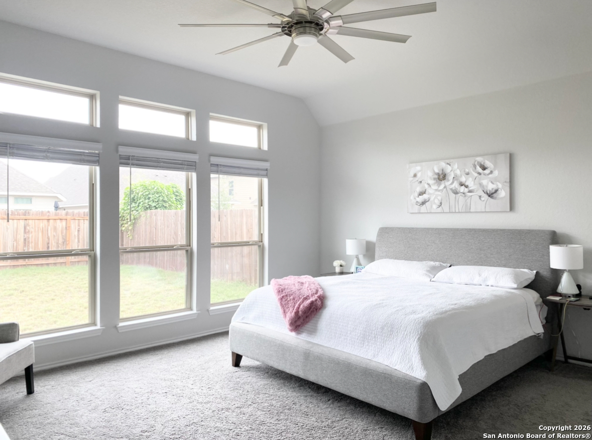 9358 Boiling Rapid San Antonio, TX 78254 - Photo 9 of 22 a bedroom with a bed and a large window