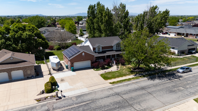5727 South 3550th Street West Roy, UT 84067 - Photo 40 of 49 Brick and siding exterior with a covered porch