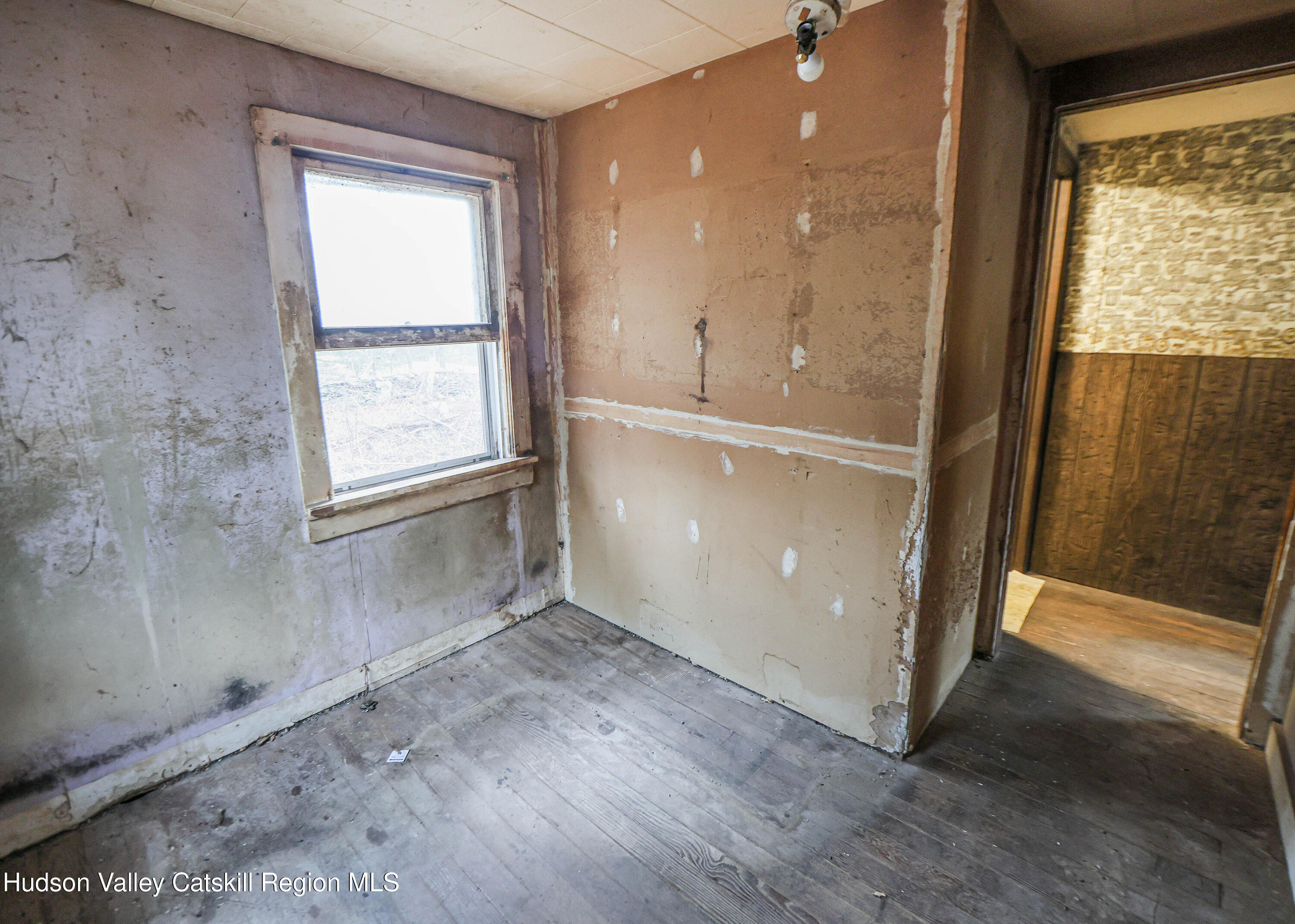 449 Spillway Road West Hurley, NY 12491 - Photo 15 of 42 a view of an empty room with a window