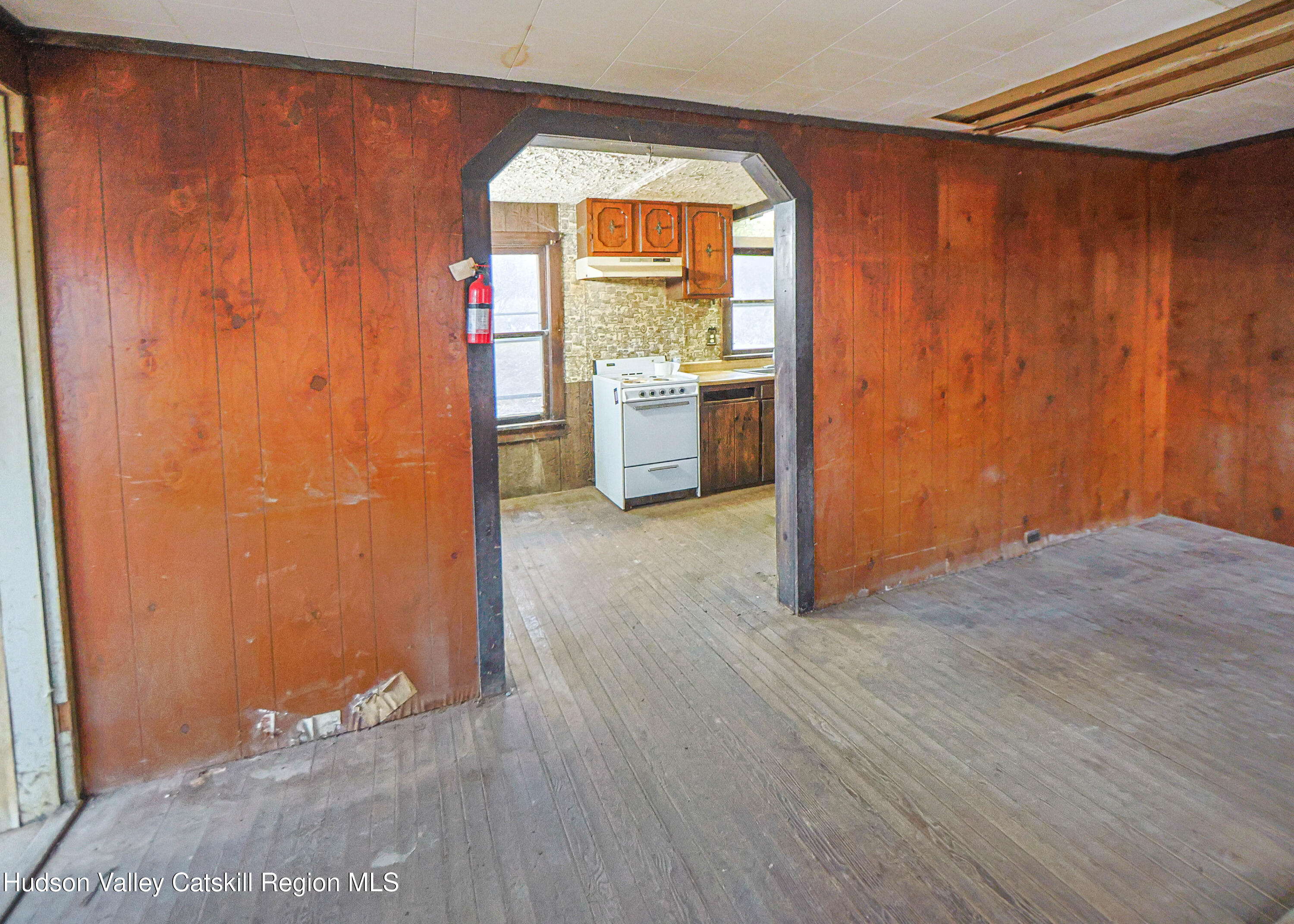 449 Spillway Road West Hurley, NY 12491 - Photo 17 of 42 an empty room with wooden floor and windows