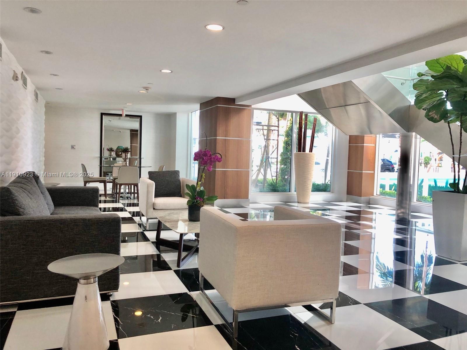 1800 North Bayshore Drive, Unit 605 Miami, FL 33132 - Photo 24 of 48 a living room with fireplace furniture and a large window