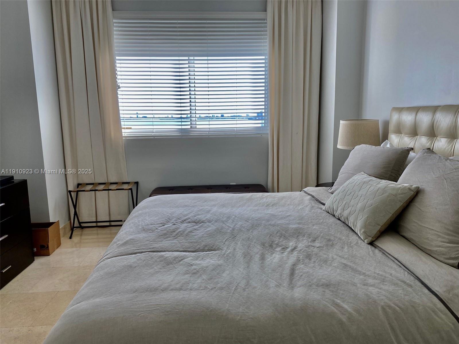 1800 North Bayshore Drive, Unit 605 Miami, FL 33132 - Photo 8 of 48 a bedroom with a bed and window