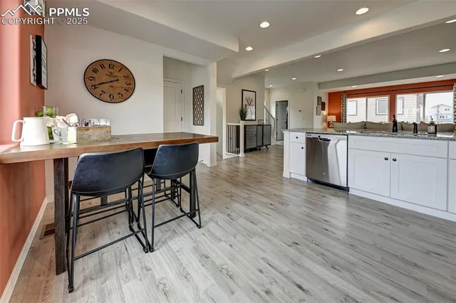a view of kitchen with granite countertop window and wooden floor
