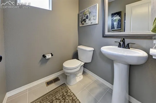a bathroom with a sink toilet and mirror