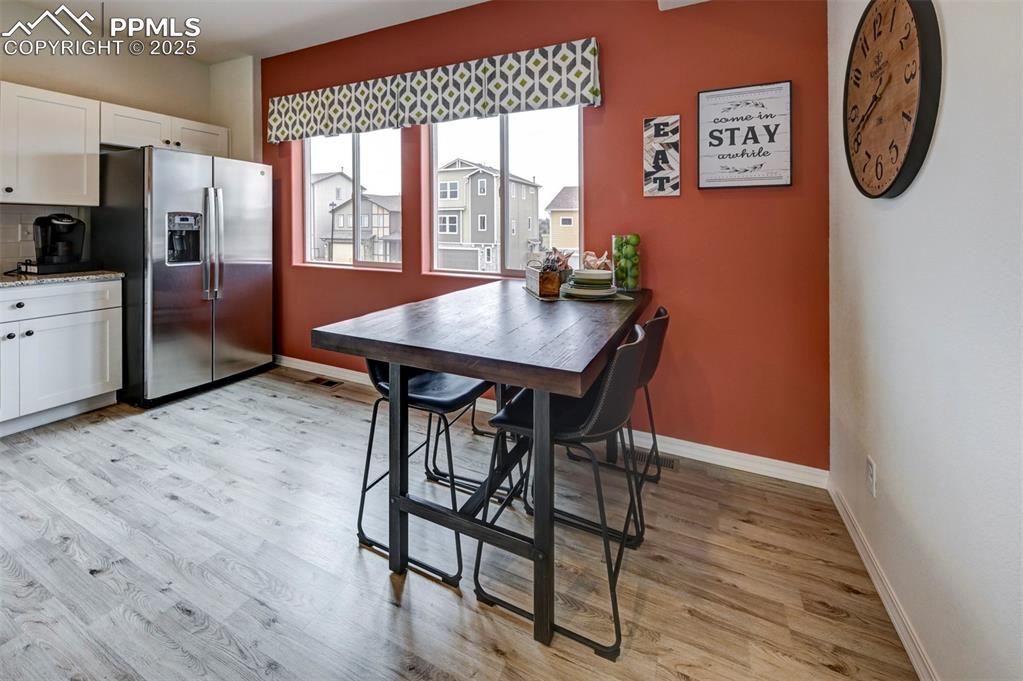 7311 Cornice Point Colorado Springs, CO 80923 - Photo 5 of 32 a view of a dining room with furniture window and wooden floor