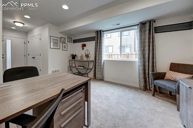 a living room with furniture a window and a table