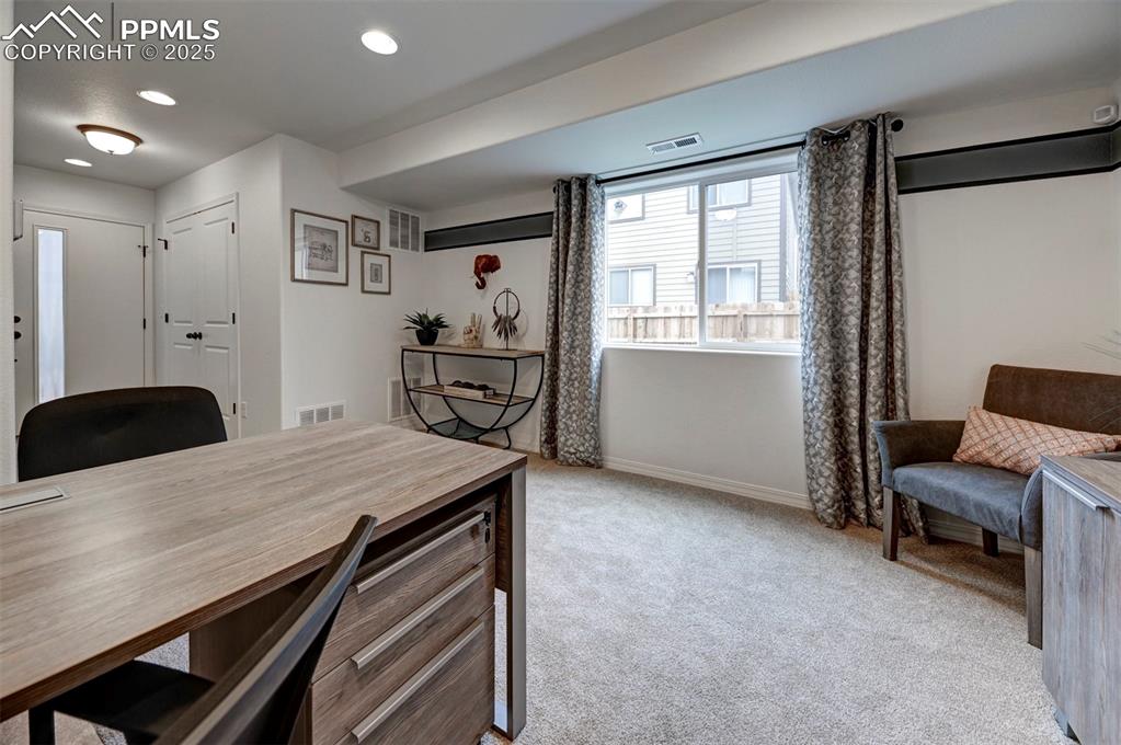 7311 Cornice Point Colorado Springs, CO 80923 - Photo 6 of 32 a living room with furniture a window and a table