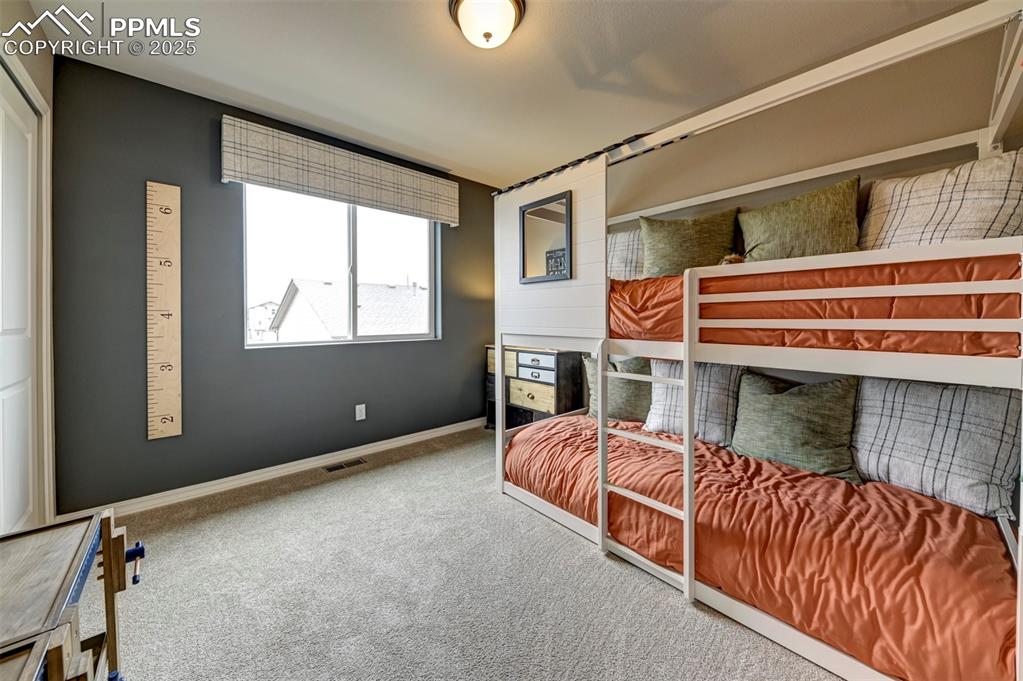 7311 Cornice Point Colorado Springs, CO 80923 - Photo 10 of 32 a bedroom with furniture and a window