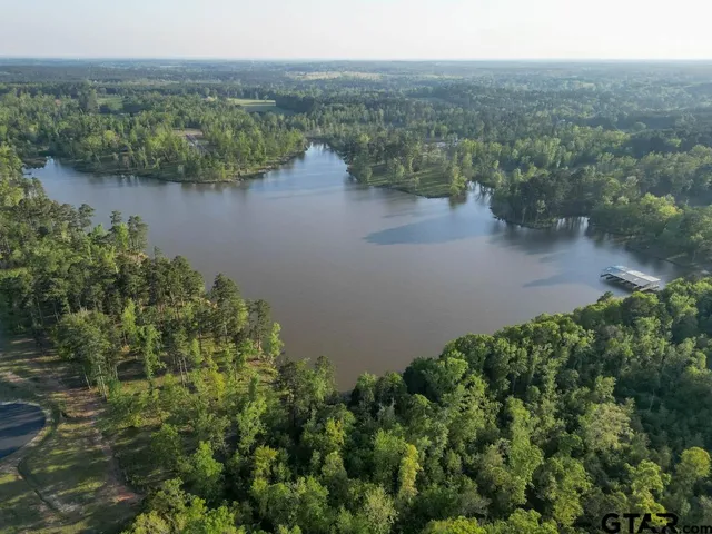 an aerial view of a house with a lake view