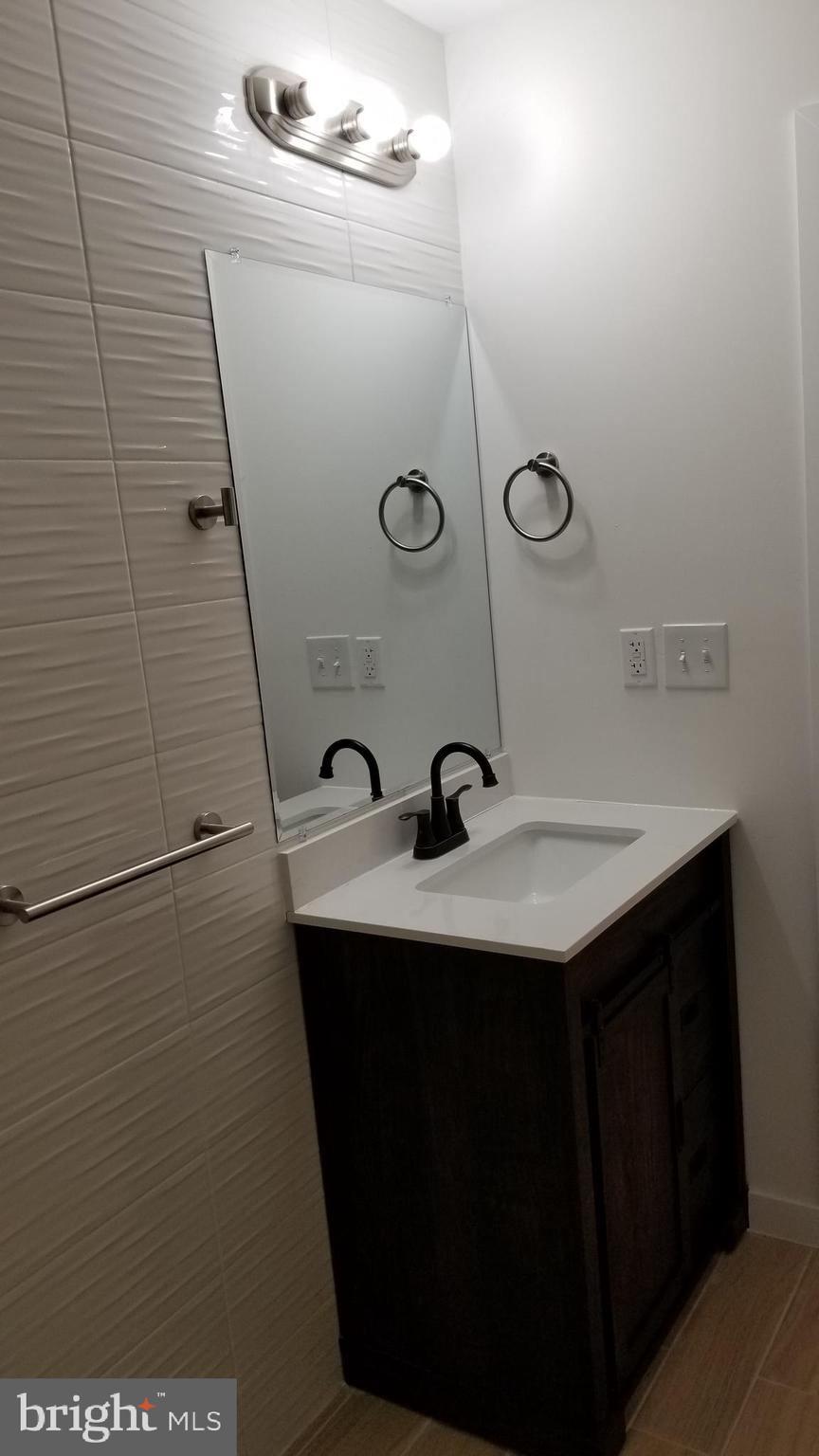 247 South 16th Street, Unit 5 Philadelphia, PA 19102 - Photo 7 of 10 a bathroom with a sink and mirror