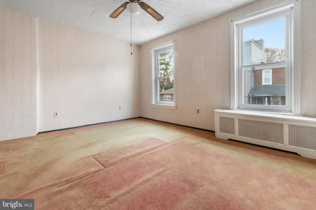 a white toilet sitting next to a bathroom sink and tub