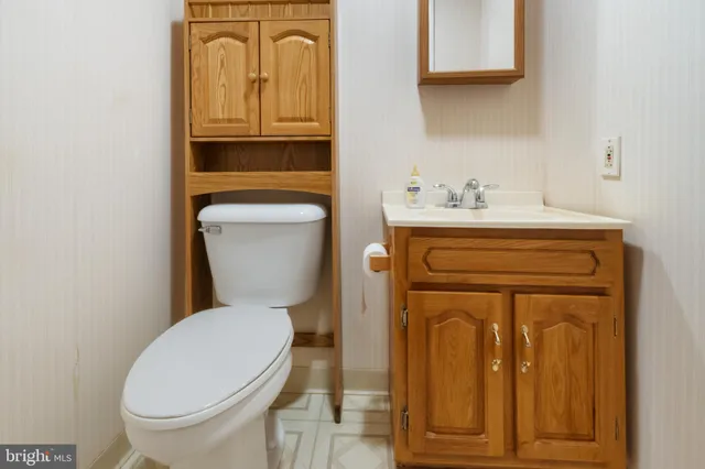 a kitchen with stainless steel appliances granite countertop a stove a sink and a microwave oven with white cabinets