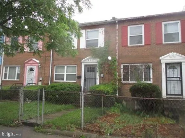 a view of house with a yard and potted plants