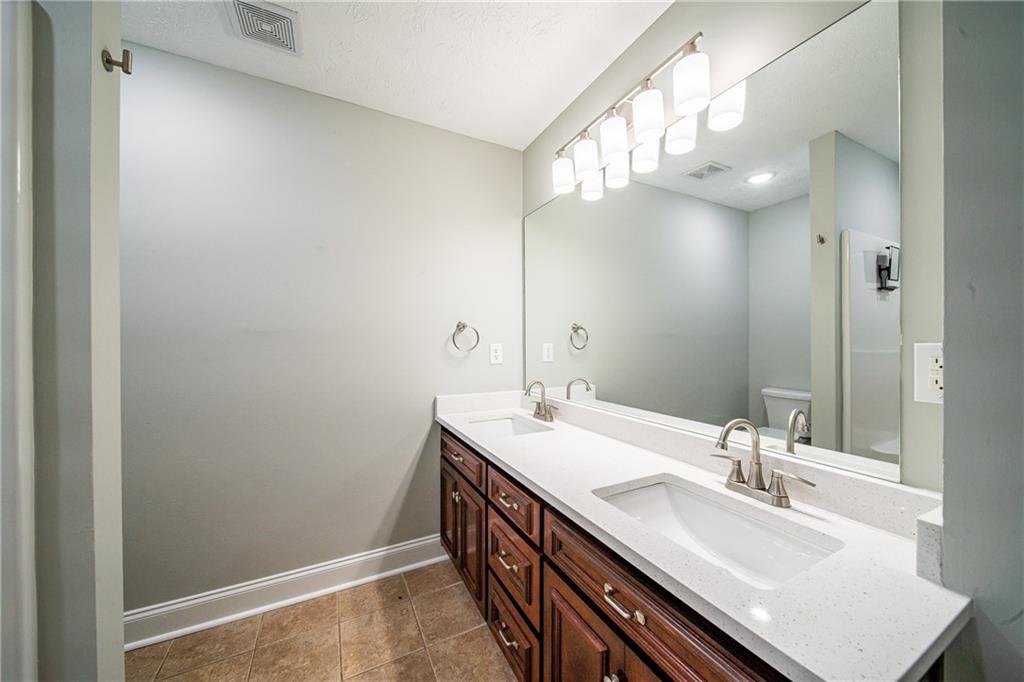 1927 Lee Road Salem, AL 36874 - Photo 35 of 45 Bathroom featuring double vanity and dark tile patterned flooring