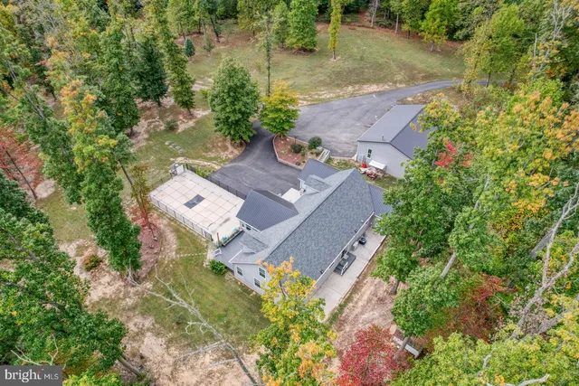 a front view of a house with swimming pool having outdoor seating
