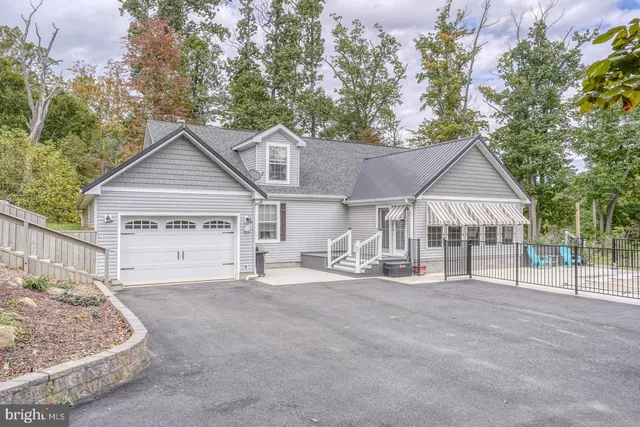 a backyard of a house with lots of green space and fountain