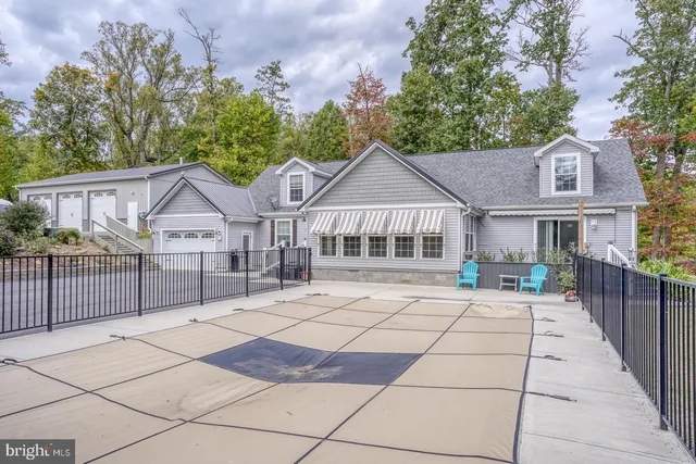 a living room with furniture and large windows