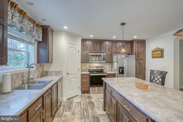 a bathroom with a granite countertop sink a toilet and bathtub