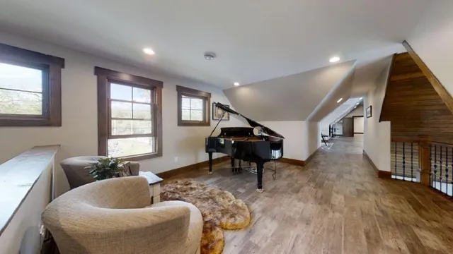 an empty room with wooden floor and white walls