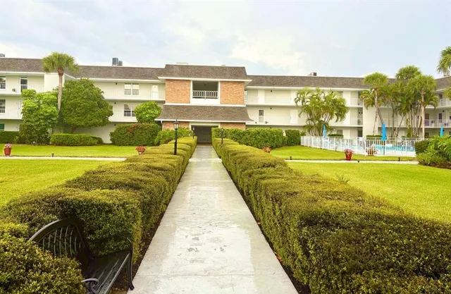 a view of swimming pool with outdoor seating and a yard