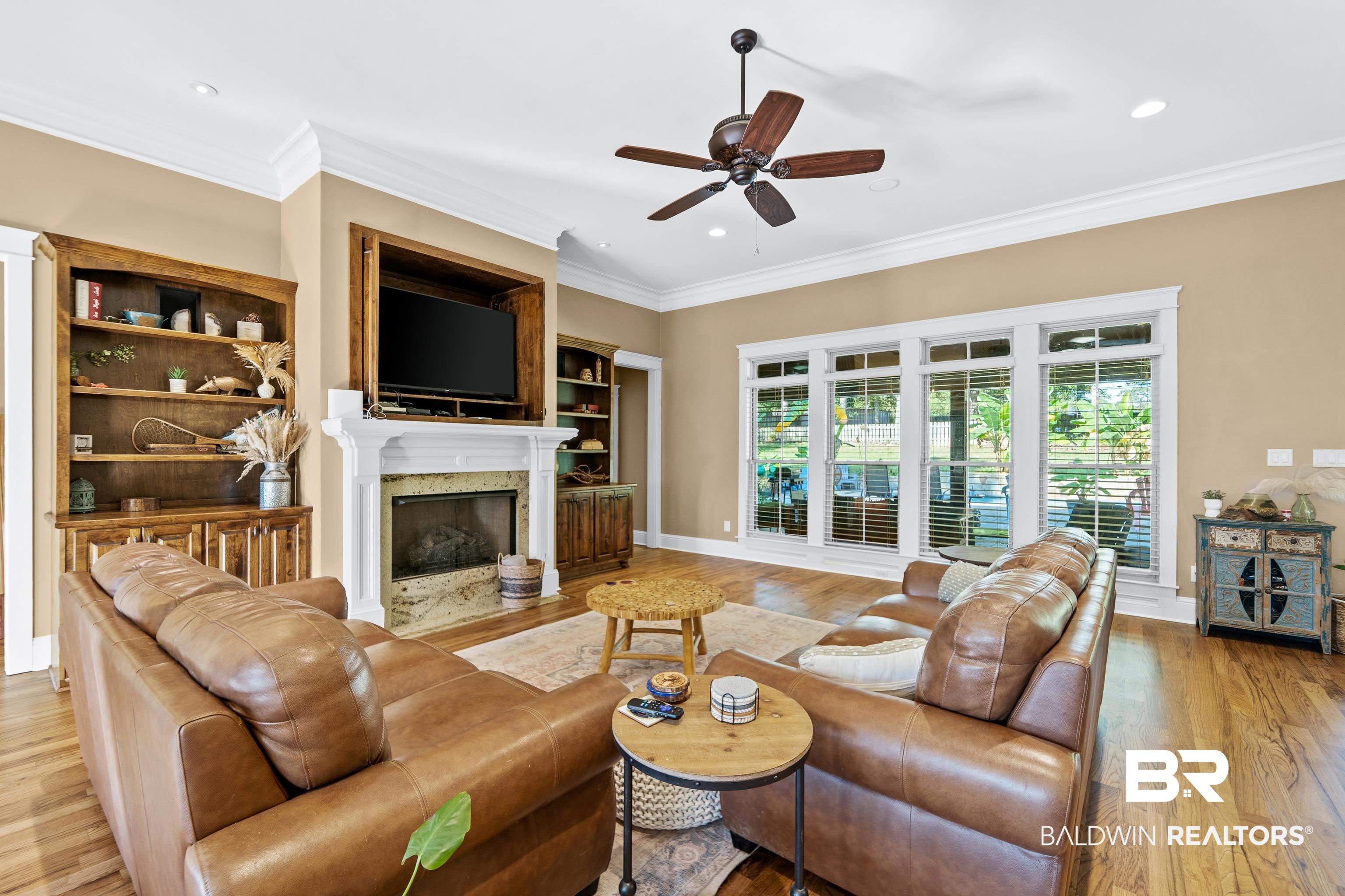 31829 Butler Drive Daphne, AL 36527 - Photo 10 of 48 Living room with light hardwood / wood-style flooring, a high end fireplace, ceiling fan, and a healthy amount of sunlight