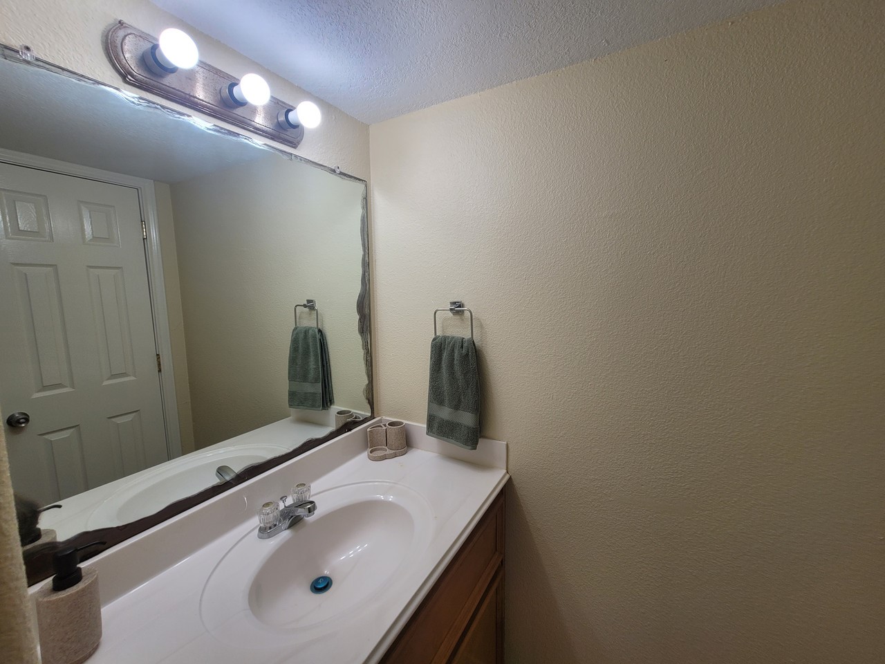 215 Postoffice Street, Unit 801 Galveston, TX 77550 - Photo 13 of 16 a bathroom with a sink vanity and a mirror