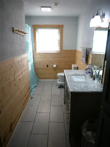 a bedroom with a bed window and a chair