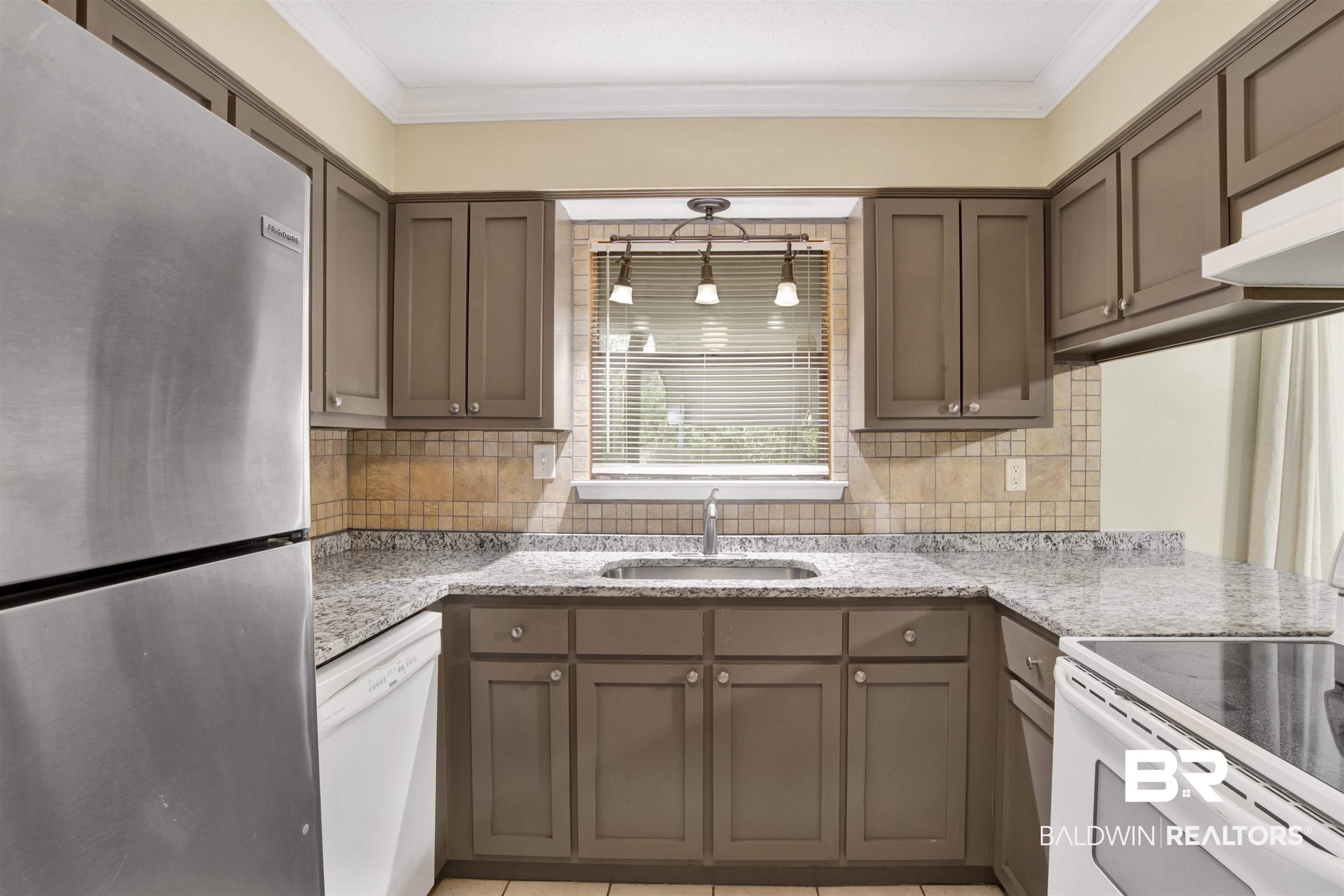 3560 Creekway Road Mobile, AL 36619 - Photo 5 of 24 Kitchen with white appliances, sink, crown molding, and backsplash