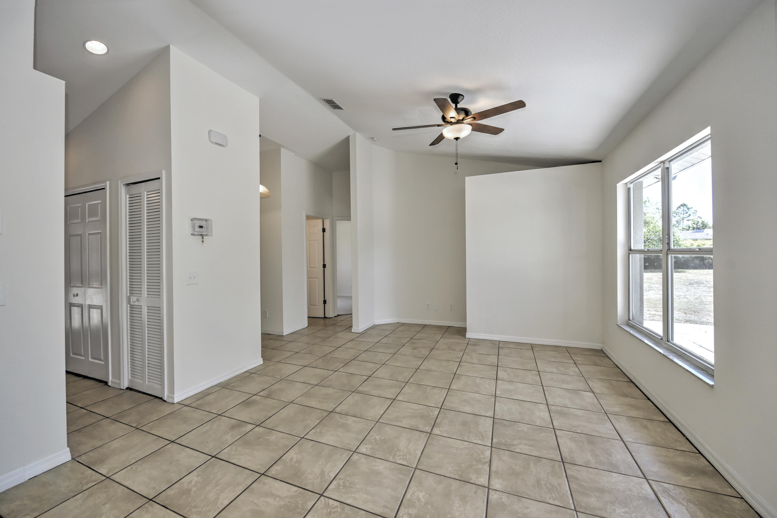 271 18th Street Southeast Naples, FL 34117 - Photo 6 of 28 a view of an empty room with a window
