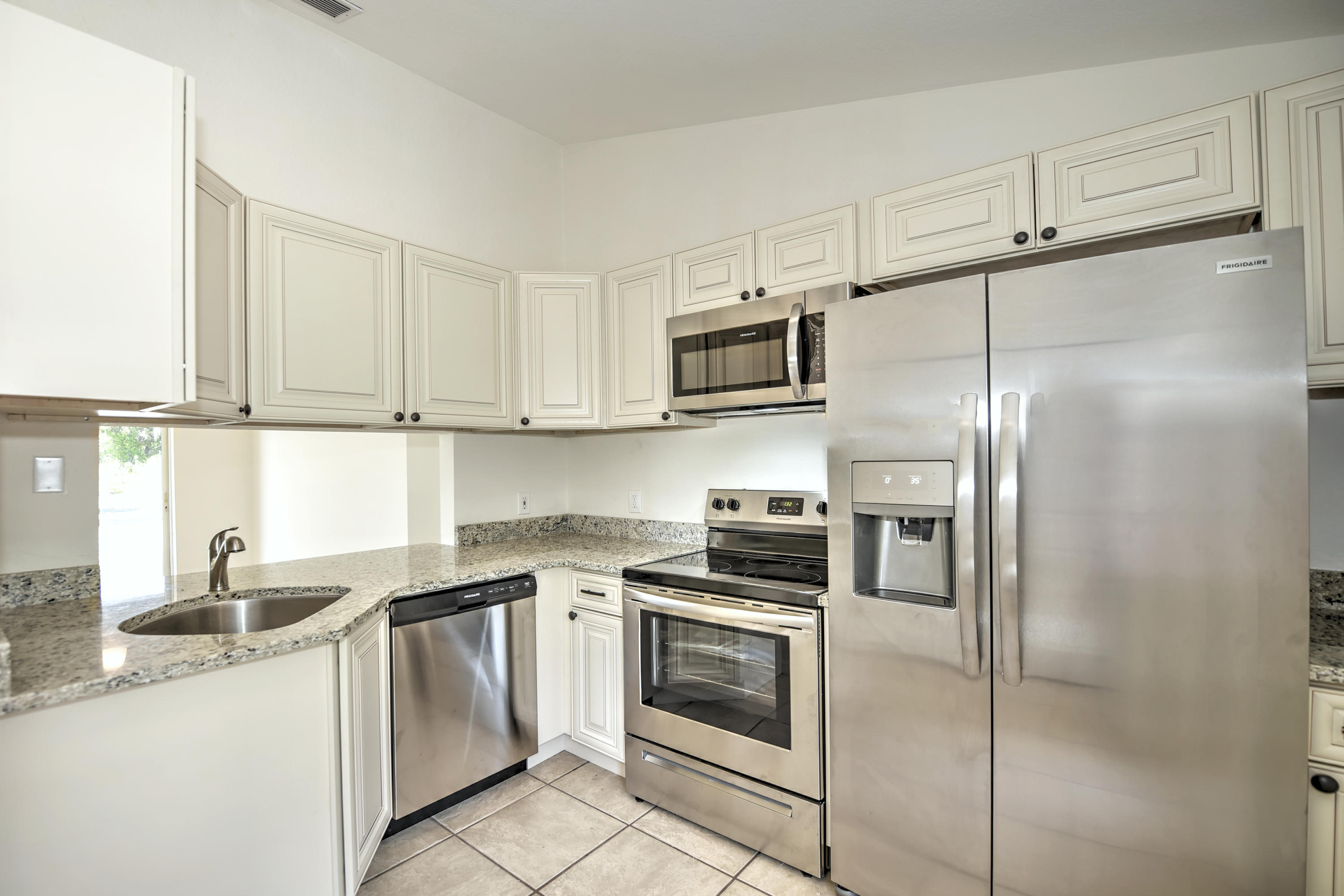 271 18th Street Southeast Naples, FL 34117 - Photo 8 of 28 a kitchen with cabinets stainless steel appliances and a sink