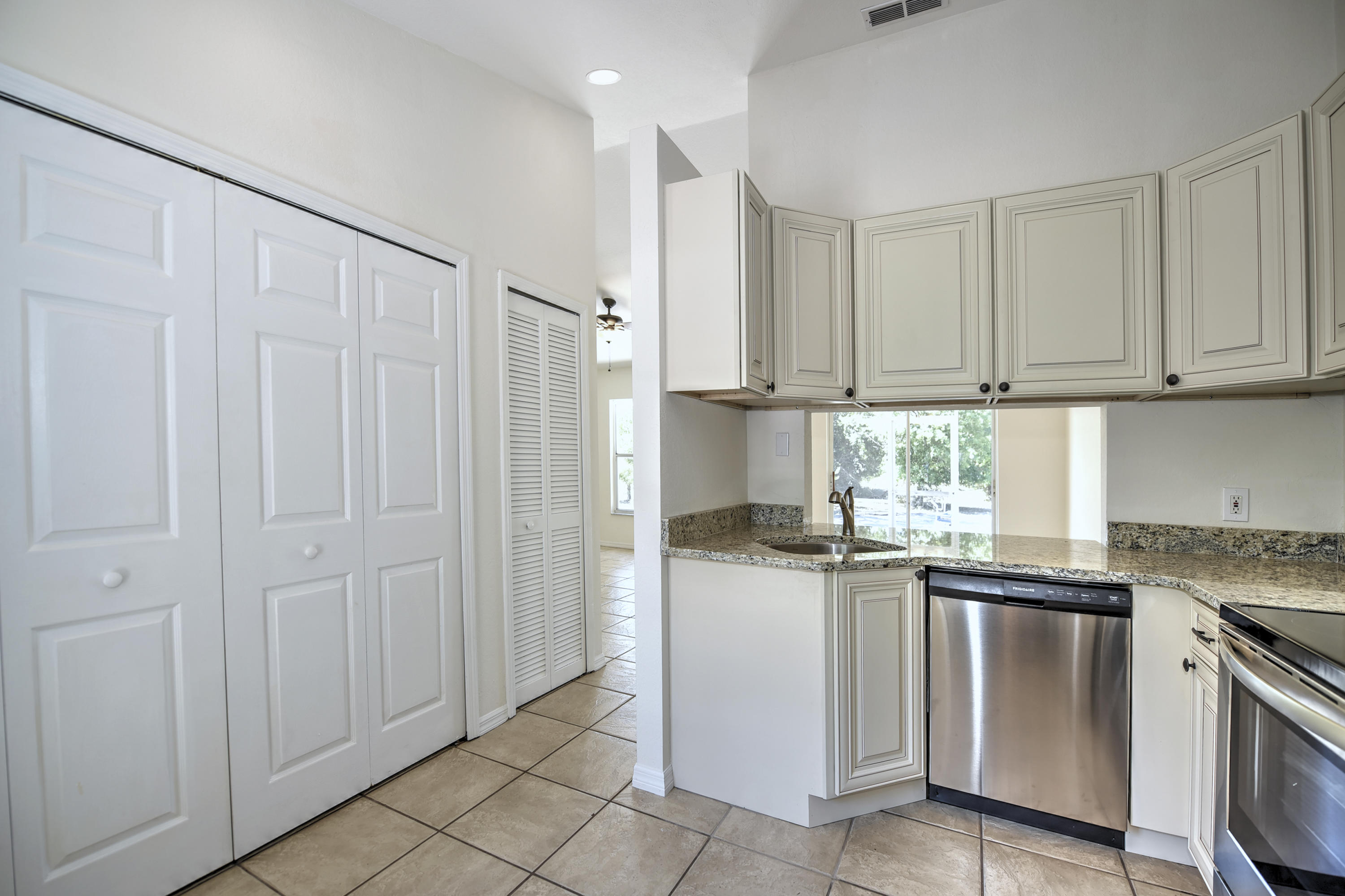 271 18th Street Southeast Naples, FL 34117 - Photo 9 of 28 a kitchen with stainless steel appliances granite countertop a sink and a refrigerator