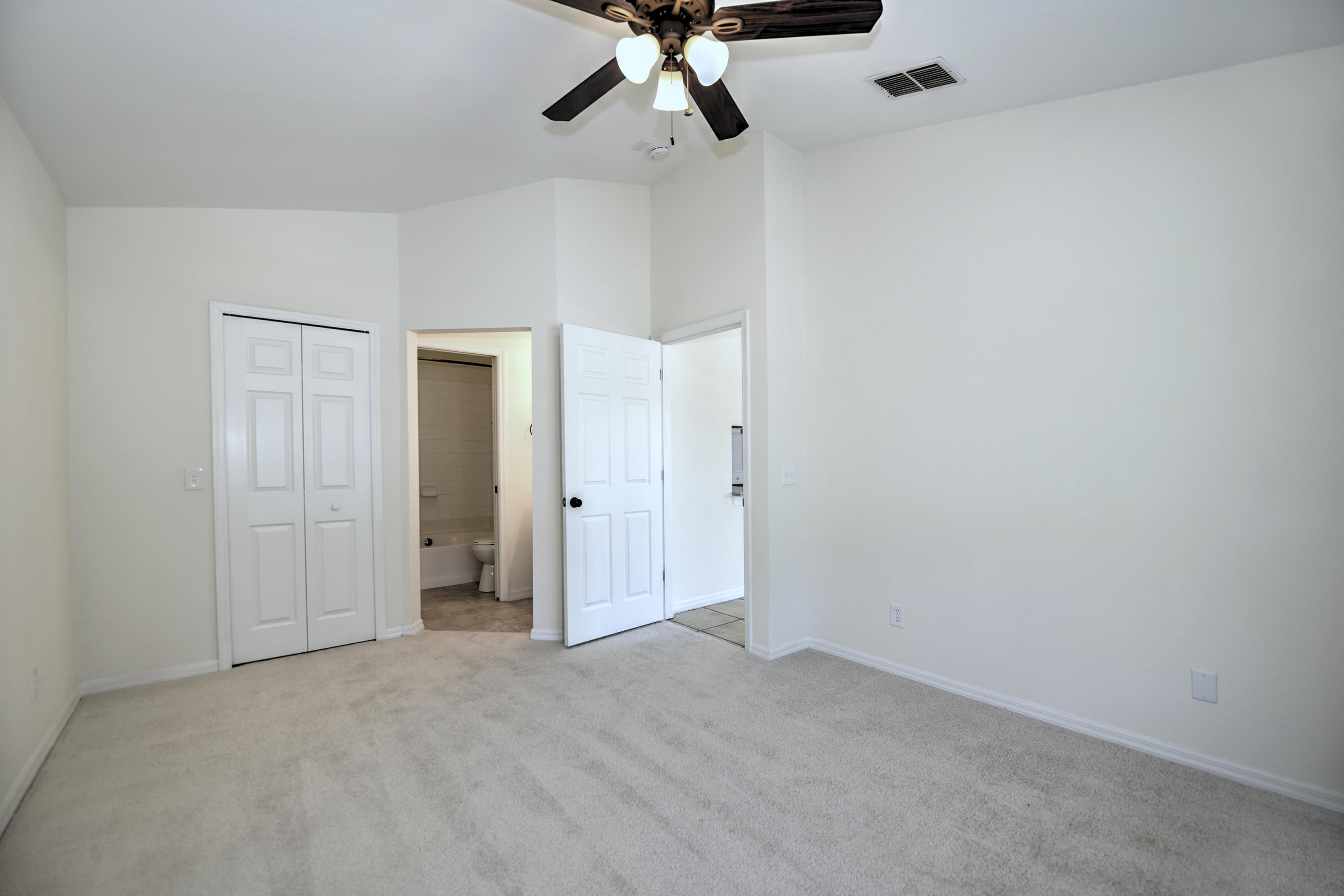 271 18th Street Southeast Naples, FL 34117 - Photo 10 of 28 a view of a room with a ceiling fan and closet