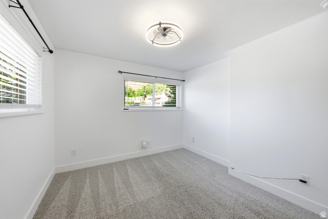 120 North 1230 E Street Springville, UT 84663 - Photo 22 of 60 Neutral-toned room featuring light gray patterned carpeting, white walls, and white baseboards