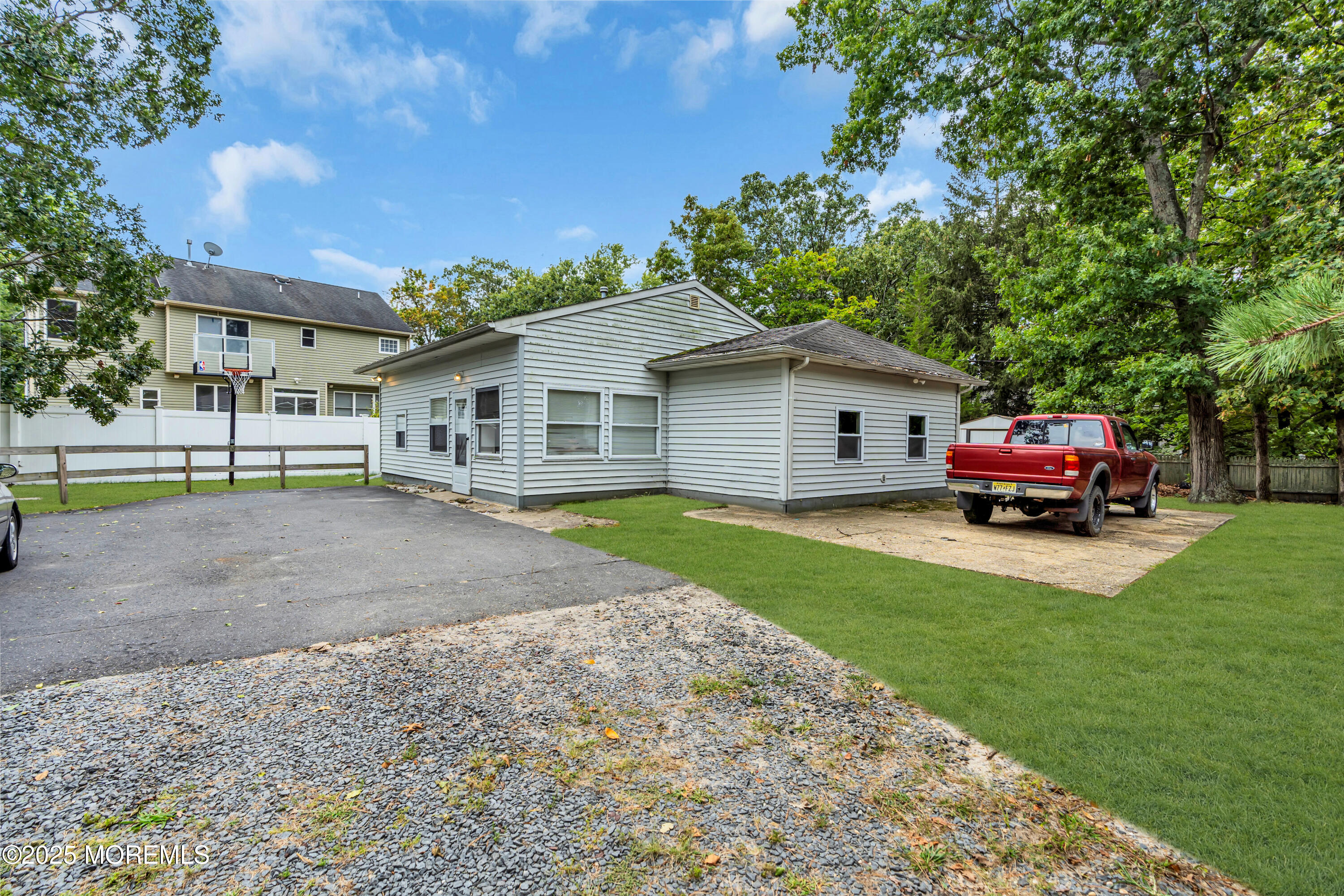 a front view of a house with a garden and trees