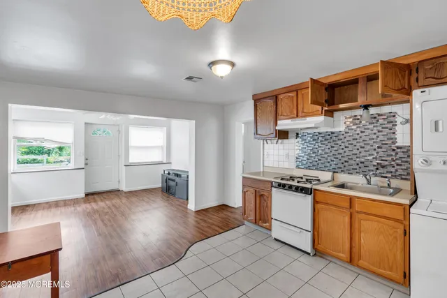 a kitchen with stainless steel appliances granite countertop a stove and a sink