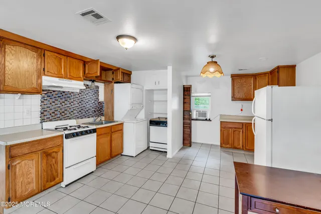 a kitchen with stainless steel appliances a refrigerator sink and stove