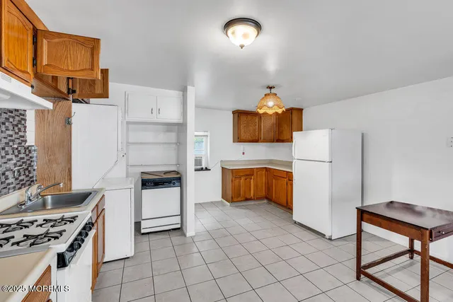 a kitchen with a stove and a refrigerator