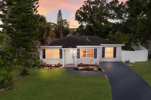 a front view of a house with a garden